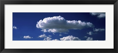 Framed Fluffy clouds in blue sky Print