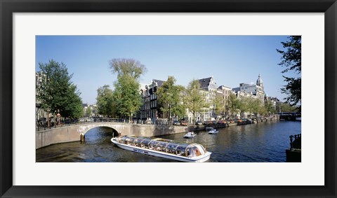 Framed Netherlands, Amsterdam, tour boat in channel Print