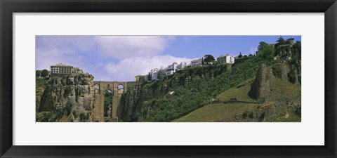 Framed Low angle view of a town, Tajo Bridge, Rio Guadalevin Gorge, Serrania De Ronda, Ronda, Andalusia, Spain Print