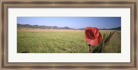 Framed USA, California, Red cowboy hat hanging on the fence Print