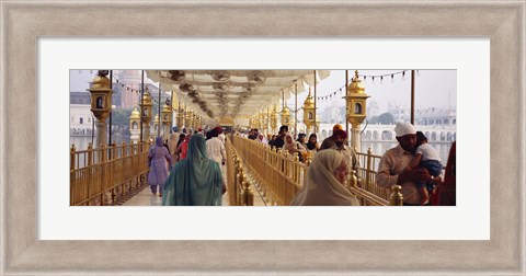 Framed Group of people walking on a bridge over a pond, Golden Temple, Amritsar, Punjab, India Print