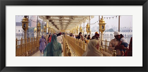 Framed Group of people walking on a bridge over a pond, Golden Temple, Amritsar, Punjab, India Print