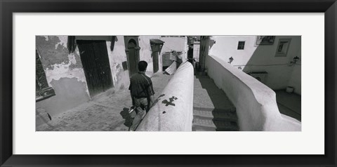 Framed Rear view of a man walking in front of a building, Casaba, Algiers, Algeria Print