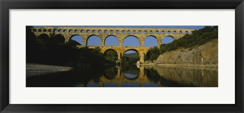 Framed Reflection of an arch bridge in a river, Pont Du Gard, France Print