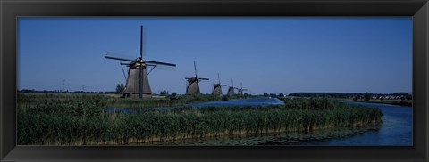 Framed Traditional windmills at a riverbank, Kinderdijk, Rotterdam, Netherlands Print