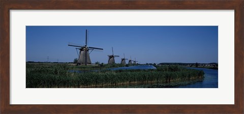 Framed Traditional windmills at a riverbank, Kinderdijk, Rotterdam, Netherlands Print