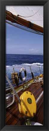 Framed Detail of the mainsheet block of a wooden sailboat in the sea Print