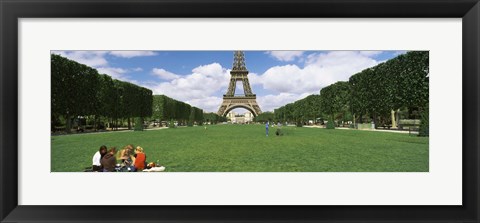 Framed Tourists sitting in a park with a tower in the background, Eiffel Tower, Paris, Ile-de-France, France Print