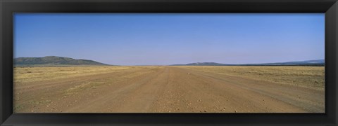 Framed Dirt road passing through a landscape, Masai Mara National Reserve, Great Rift Valley, Kenya Print