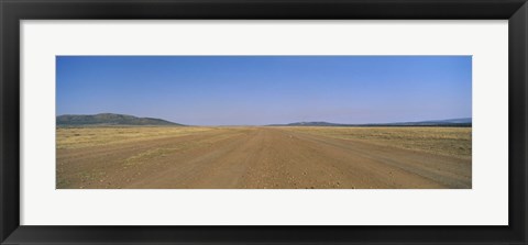 Framed Dirt road passing through a landscape, Masai Mara National Reserve, Great Rift Valley, Kenya Print