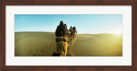 Framed Row of people riding camels through the desert, Sahara Desert, Morocco Print