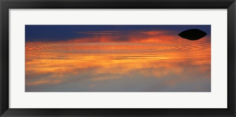 Framed Reflection of clouds with circular ripples spreading outward across glassy lake waters at sunset Print