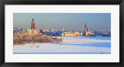 Framed People strolling across frozen Riddarfjarden, Riddarholmen, Stockholm, Sweden Print