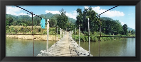 Framed Old wooden bridge across the river, Chiang Mai Province, Thailand Print