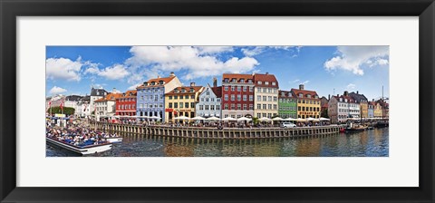 Framed Tourists in a tourboat with buildings along a canal, Nyhavn, Copenhagen, Denmark Print