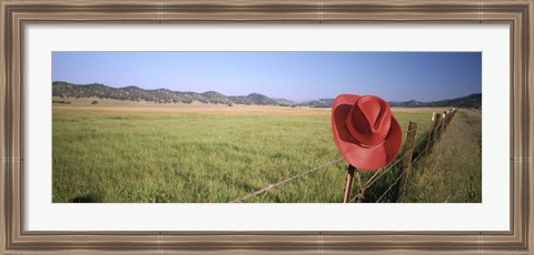 Framed USA, California, Red cowboy hat hanging on the fence Print