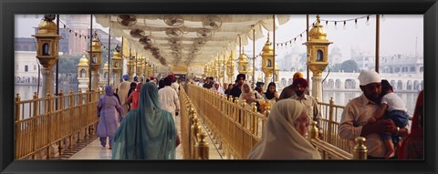 Framed Group of people walking on a bridge over a pond, Golden Temple, Amritsar, Punjab, India Print