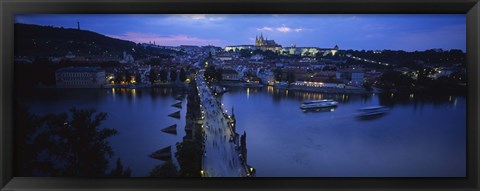 Framed High angle view of buildings lit up at dusk, Charles Bridge, Vltava River, Prague, Czech Republic Print