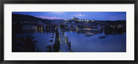 Framed High angle view of buildings lit up at dusk, Charles Bridge, Vltava River, Prague, Czech Republic Print