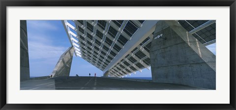 Framed Four people under a structure, Barcelona, Catalonia, Spain Print