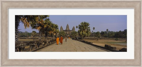 Framed Two monks walking in front of an old temple, Angkor Wat, Siem Reap, Cambodia Print