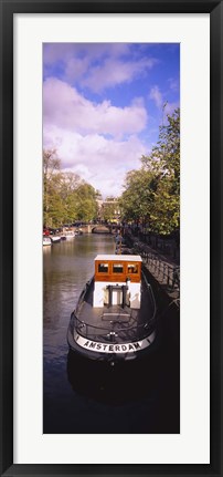 Framed Tourboat docked in a channel, Amsterdam, Netherlands Print