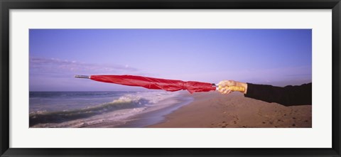 Framed Close-up of a woman&#39;s hand pointing with a red umbrella, Point Reyes National Seashore, California, USA Print