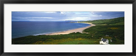 Framed Birds-eye view of sea, white stone cottage, Northern Ireland. Print