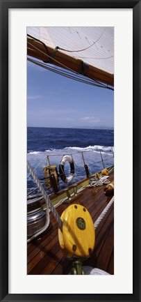 Framed Detail of the mainsheet block of a wooden sailboat in the sea Print