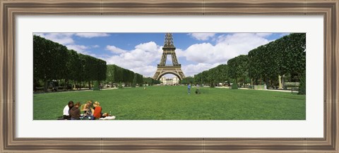 Framed Tourists sitting in a park with a tower in the background, Eiffel Tower, Paris, Ile-de-France, France Print