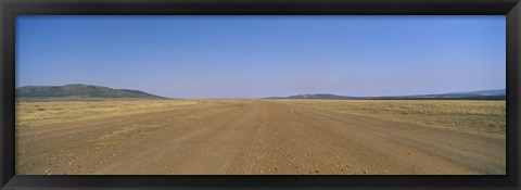 Framed Dirt road passing through a landscape, Masai Mara National Reserve, Great Rift Valley, Kenya Print