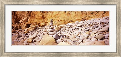 Framed Stack of stones on the beach, California, USA Print