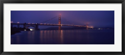 Framed Suspension bridge lit up at dawn viewed from fishing pier, Golden Gate Bridge, San Francisco Bay, San Francisco, California, USA Print