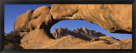 Framed Mountains viewed through a natural arch with a mother holding her baby, Spitzkoppe, Namib Desert, Namibia Print