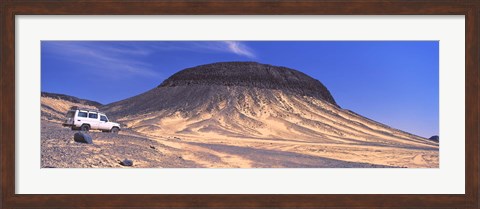 Framed SUV moving in a desert, Black Desert, Bahariya Oasis, Egypt Print