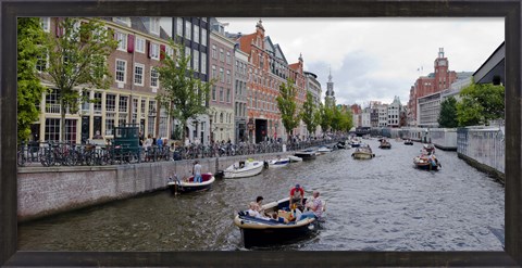 Framed Tourboats in a canal, Amsterdam, Netherlands Print