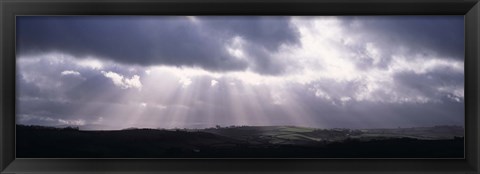 Framed Sunbeams radiating through dark clouds over rolling hills, Dartmoor, Devon, England Print