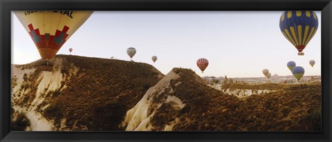 Framed Hot air balloons soaring over a mountain ridge, Cappadocia, Central Anatolia Region, Turkey Print