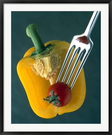 Framed Close up of half yellow pepper with cherry tomato in center on fork tines Print