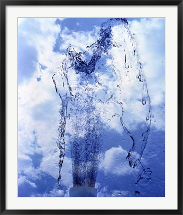 Framed Slow motion geyser of water rising through blue sky and clouds Print