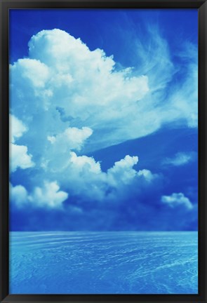 Framed White clouds in dark blue sky over rippling water Print