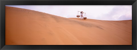 Framed Rear view of a woman carrying panniers, Mui Ne, Vietnam Print