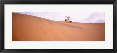 Framed Rear view of a woman carrying panniers, Mui Ne, Vietnam Print