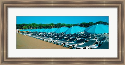 Framed Parasols with lounge chairs on a private beach in summer morning light, French Riviera, France Print