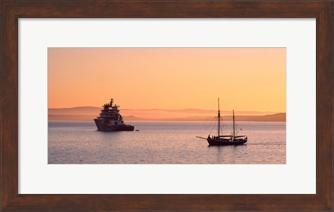 Framed Tugboat and a tall ship in the Baie de Douarnenez at sunrise, Finistere, Brittany, France Print