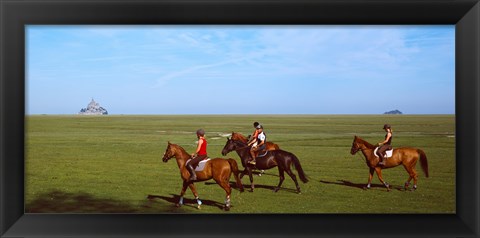 Framed Horseback riders in a field with Mont Saint-Michel island in background, Manche, Basse-Normandy, France Print