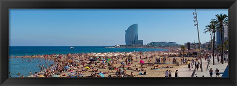 Framed Tourists on the beach with W Barcelona hotel in the background, Barceloneta Beach, Barcelona, Catalonia, Spain Print