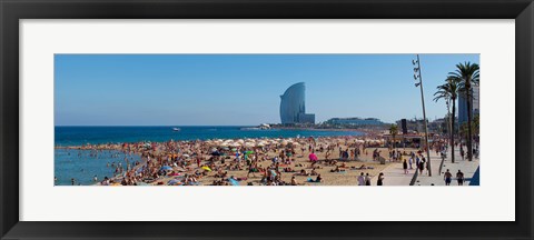 Framed Tourists on the beach with W Barcelona hotel in the background, Barceloneta Beach, Barcelona, Catalonia, Spain Print