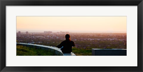 Framed Man sting on the ledge in Baldwin Hills Scenic Overlook Park, Culver City, Los Angeles County, California, USA Print