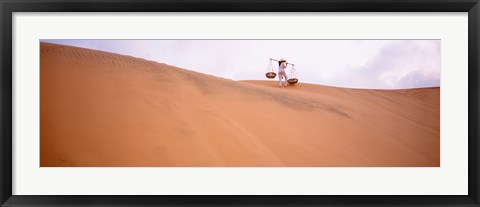 Framed Rear view of a woman carrying panniers, Mui Ne, Vietnam Print